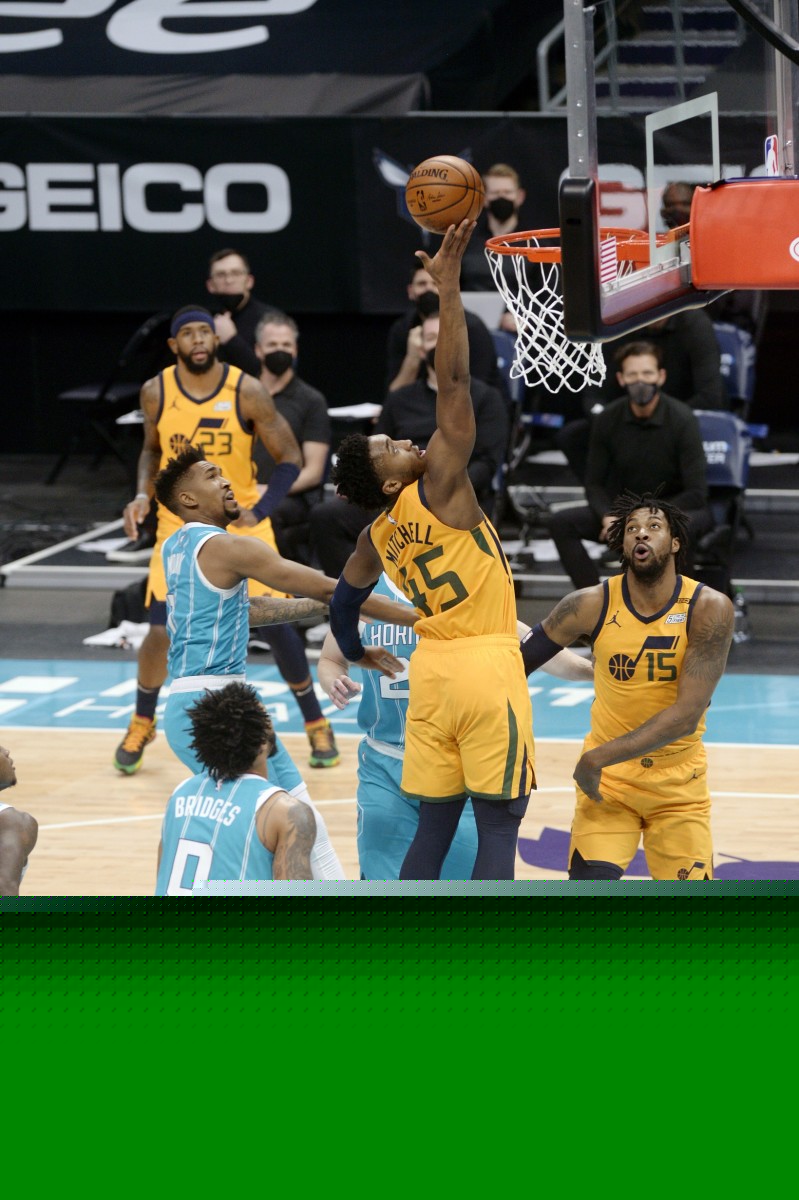 Donovan Mitchell (45) with a layup over Miles Bridges (0)